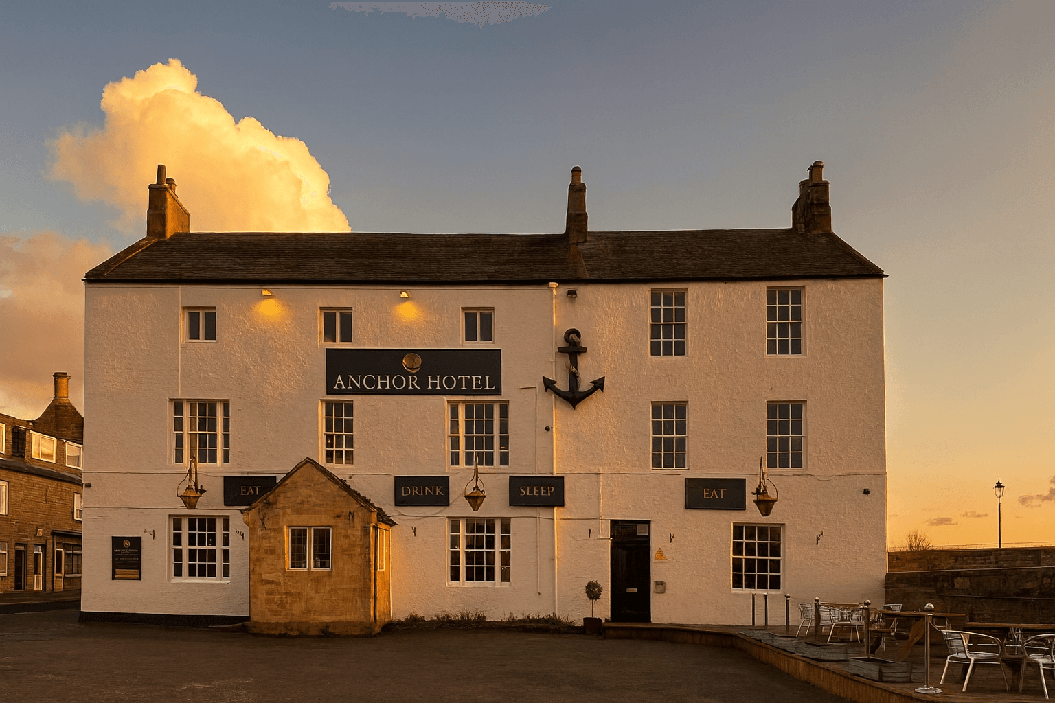 Riverside exterior of The Anchor at dusk