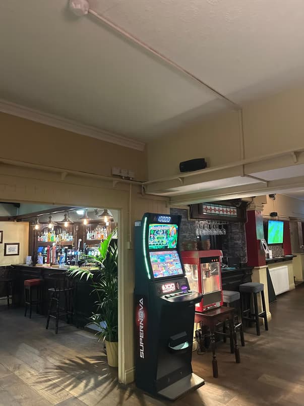 Judge & Barrel Bar interior with arcade machine and bar counter